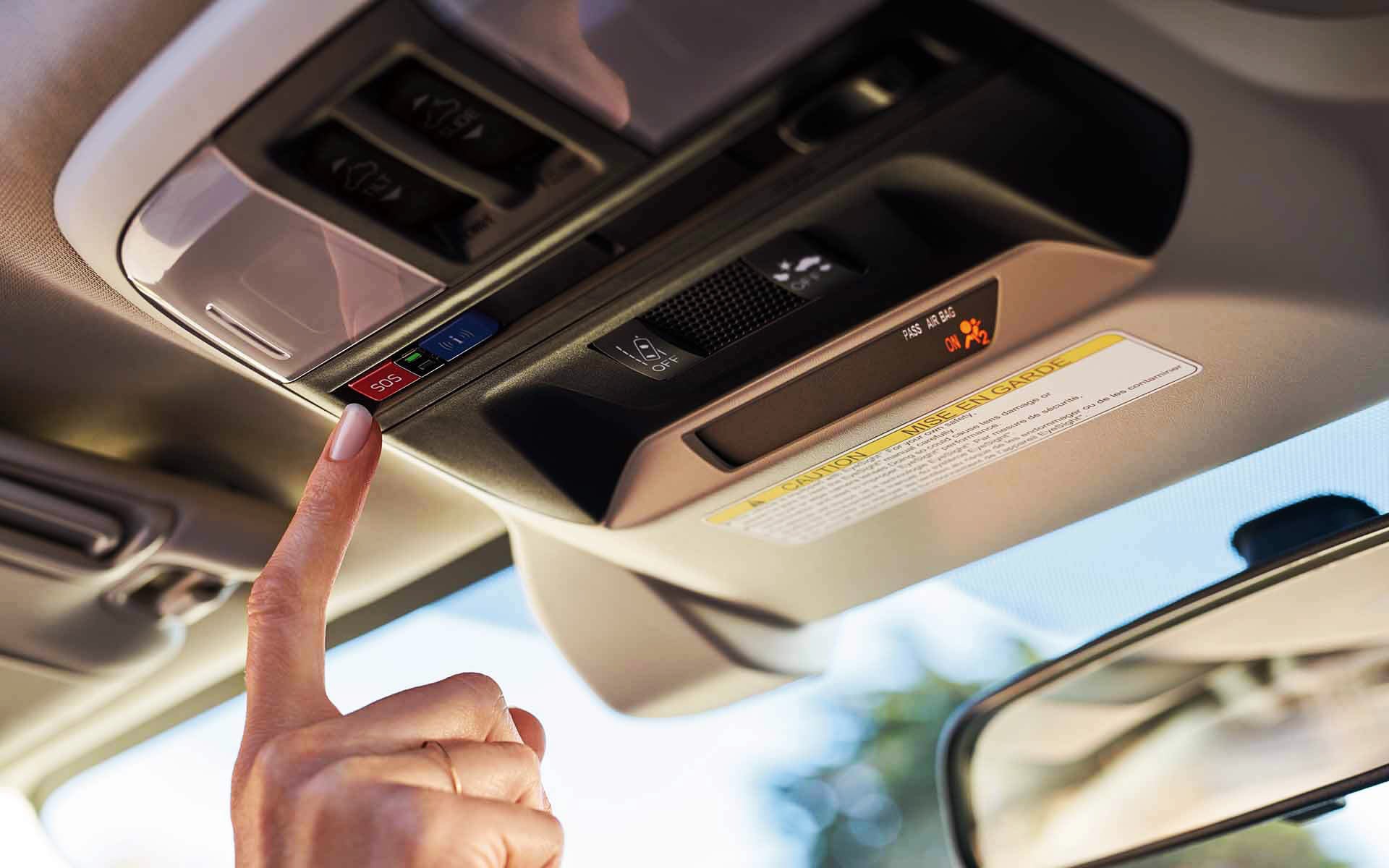 A finger pressing the Crosstrek Hybrid's SOS emergency assistance button | Subaru Superstore of Surprise in Surprise AZ