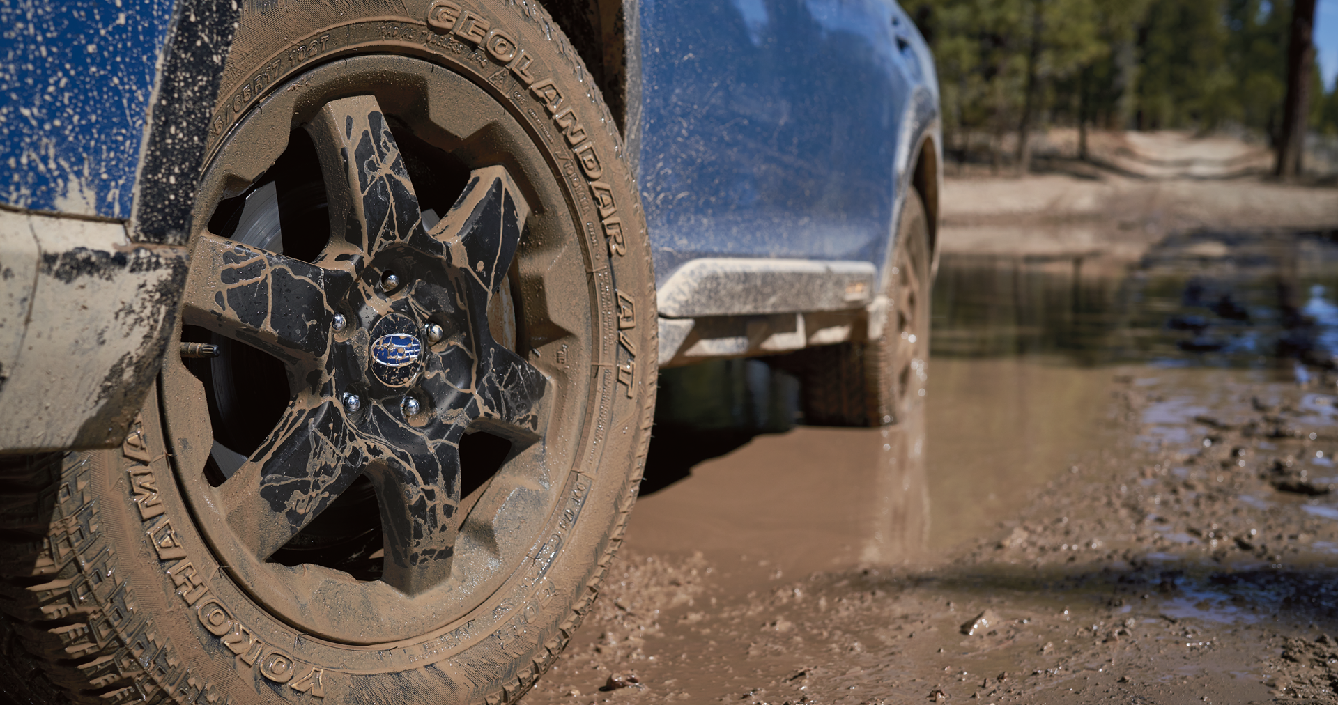 A close-up of the 17-inch off-road wheels and all-terrain Yokohama GEOLANDAR® tires on the 2023 Outback Wilderness. | Subaru Superstore of Surprise in Surprise AZ
