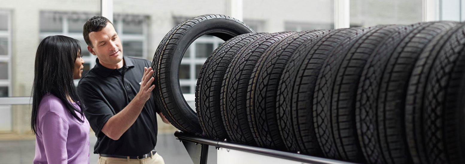 Subaru service representative showing customer a tire. | Subaru Superstore of Surprise in Surprise AZ