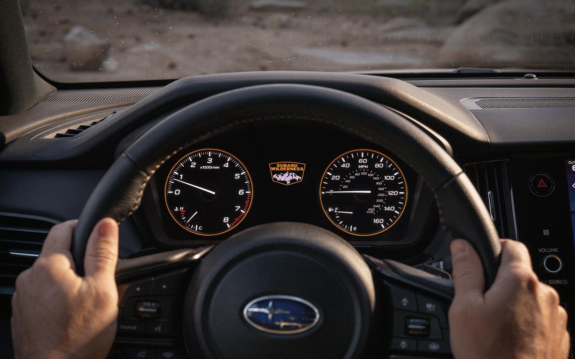 A Subaru Wilderness Steering Wheel and Gauge Cluster